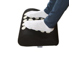 Person using acupressure foot rest under desk to relieve foot pain, improve circulation and reduce fatigue during long sitting at home or office