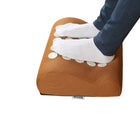 Person using acupressure foot rest under desk to relieve foot pain, improve circulation and reduce fatigue during long sitting at home or office
