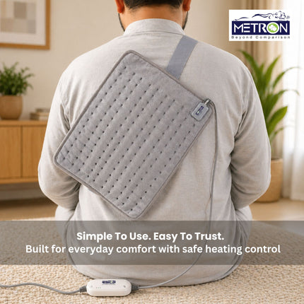 Heating pad worn across back with adjustable strap for daily comfort and targeted back pain relief at home by Metron