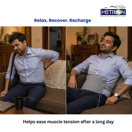 Man relaxing on sofa using heating pad after long day to ease muscle tension and back pain naturally at home by Metron