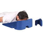 man using wedge face down pillow after eye surgery for prone position recovery at home