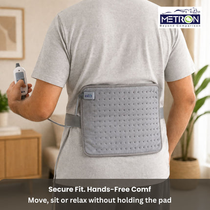 Heating pad worn on back with strap for hands free use allowing movement while getting continuous pain relief by Metron
