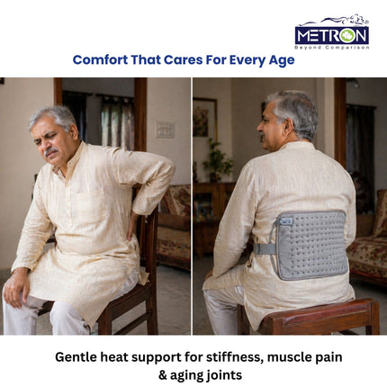 Elderly man using heating pad for joint stiffness and back pain relief at home with safe heat therapy solution by Metron