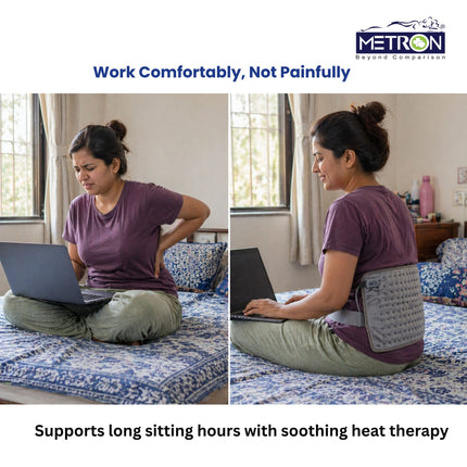 Woman working on laptop with back pain and using heating pad for relief during long sitting hours at home by Metron